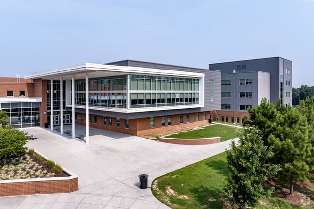 Green Level High School athletics branding across social media, newsletter, and on-campus digital displays